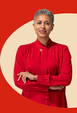 With arms folded, a mature female State Farm agent in a red blouse and scarf smiles.