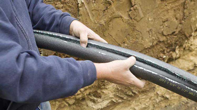 Person holding a broken pipe.