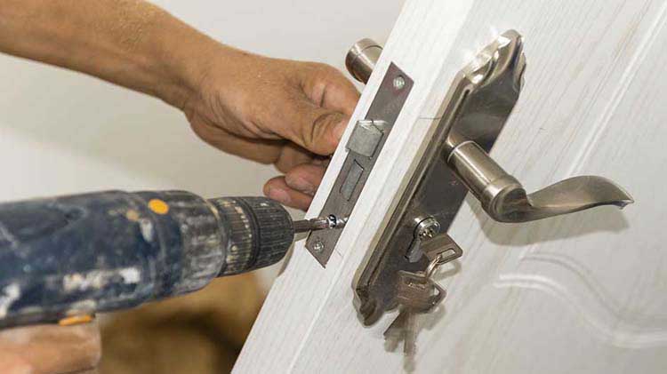 Person installing a door lock.