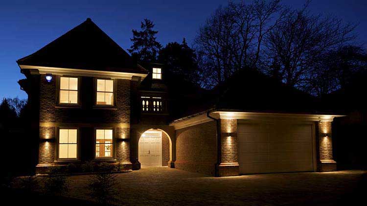 A house at night with a home security system turned on.