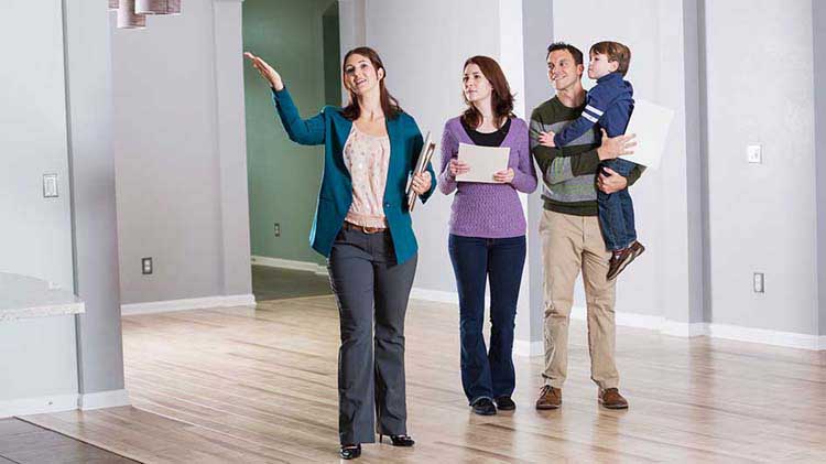 A Realtor showing a home to a young family