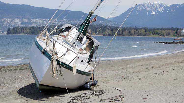 Boat shipwrecked on beach.
