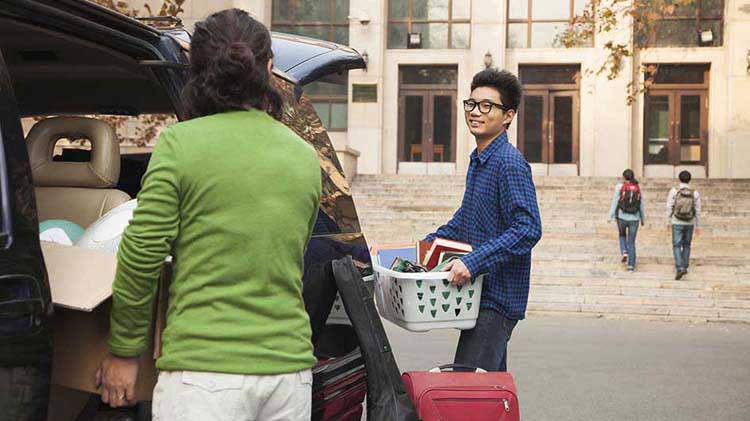 Mom helping son move into dorm