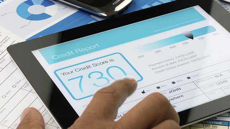 A credit score is shown on a tablet.