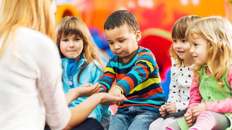 Child care worker with little kids.