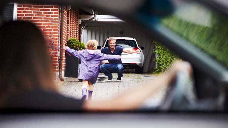 Newly divorced father greets his daughter after her mother drops her off.