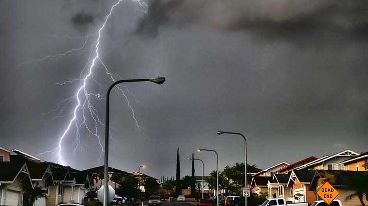 Lightning striking in a residential neighborhood.
