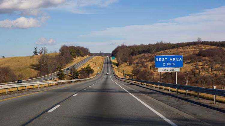 Driving on the open road and looking for rest areas.