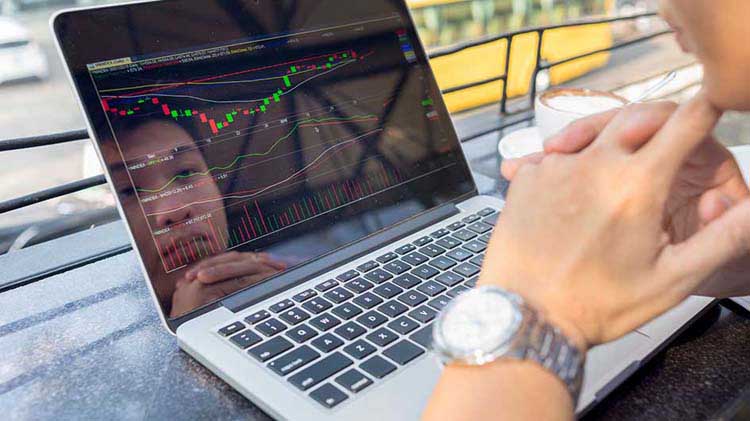 Man viewing fund performance on a laptop screen.