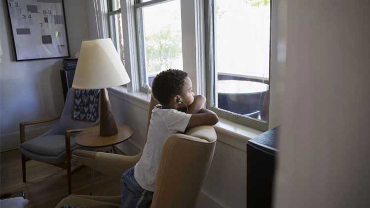 Child looking out a window.