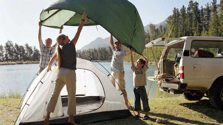 Family setting up a tent for camping