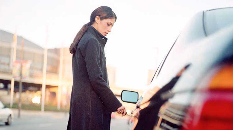 Woman unlocking her car door.