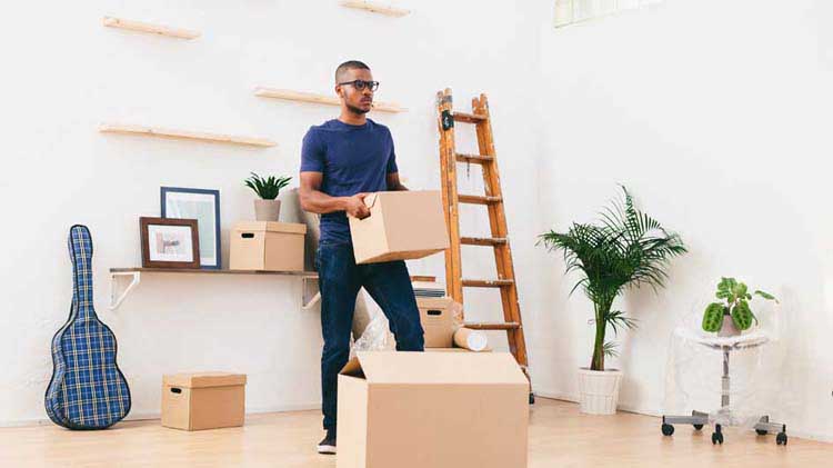 Man packing up his apartment.