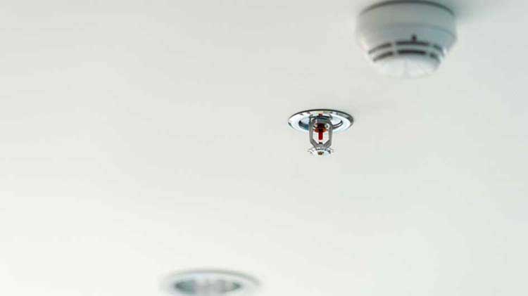 Automatic sprinkler system on a ceiling.