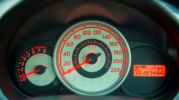 Car dashboard showing tachometer, speedometer, and odometer.
