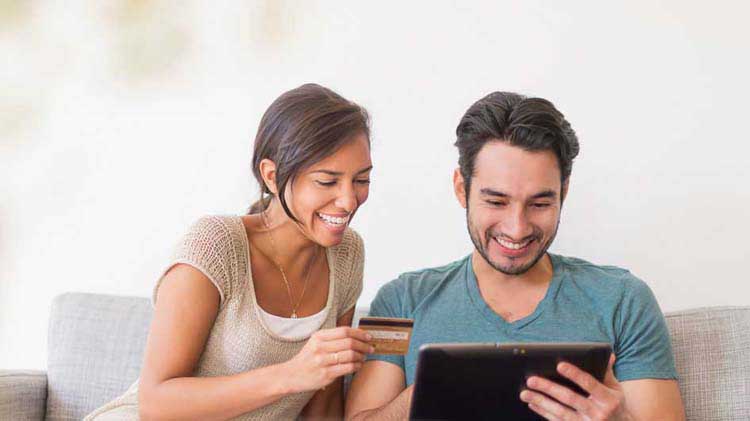 Couple shopping online with a credit card.