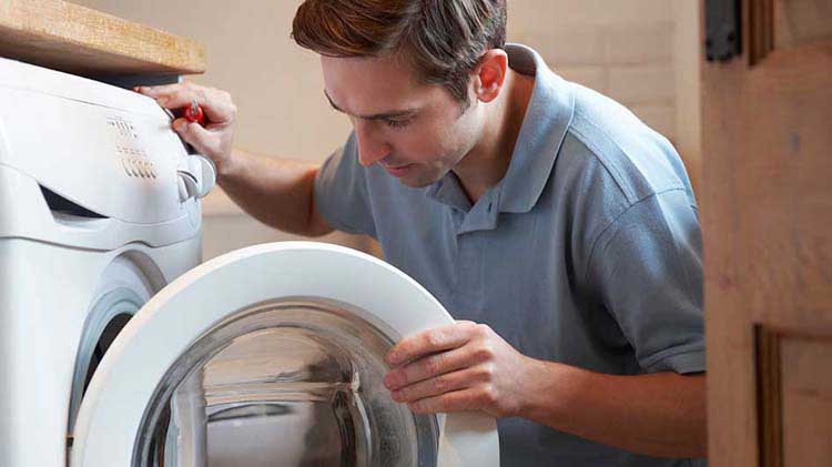 Man looking inside washing machine