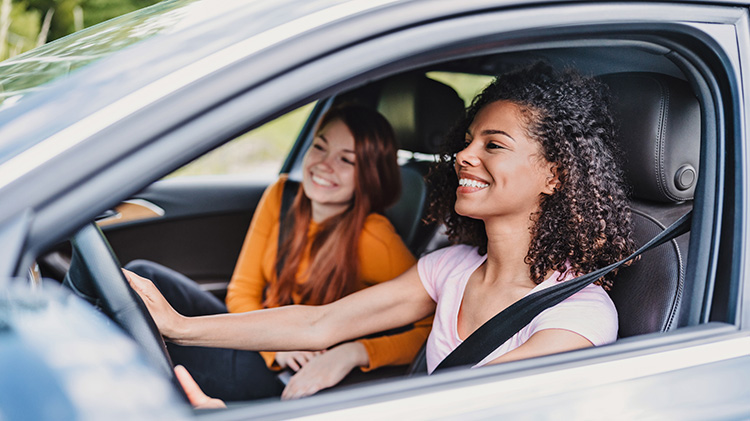 Two young roommates are traveling by car.