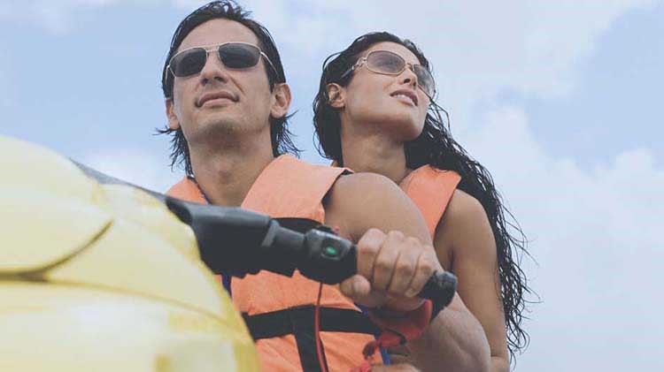 Couple riding a jet ski for the first time.