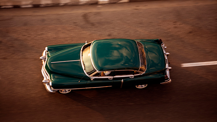 High angle view of a classic car driving down the street.