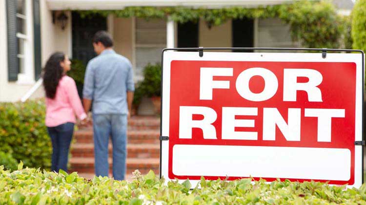Red and white "FOR RENT" sign in front of house with a couple holding hands in the background.