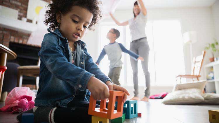 Mom playing with 2 kids in a smoke-free environment.