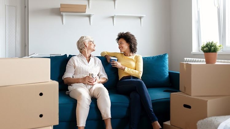 Mujer e hija mudándose a una vivienda más pequeña.