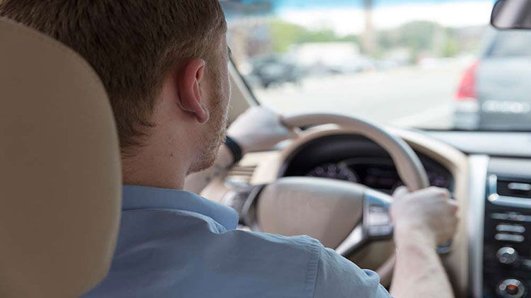 Man inside car while driving on the interstate.