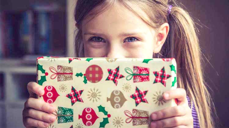 Little girl holding a Christmas present