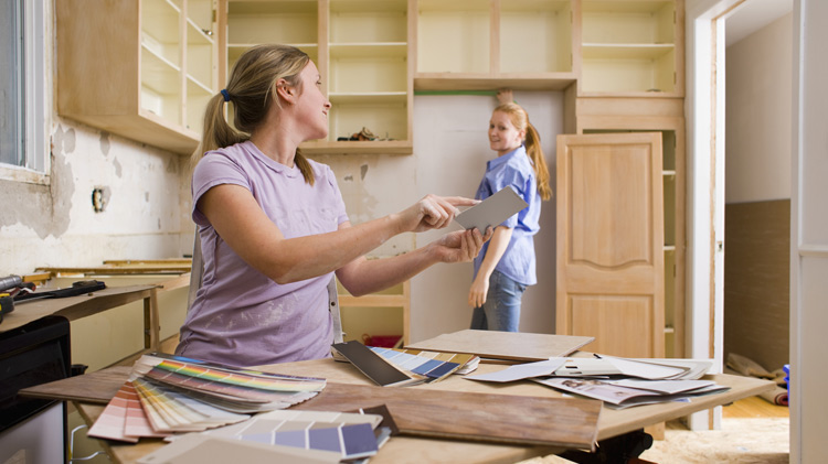 Women remodeling a kitchen and selecting colors.