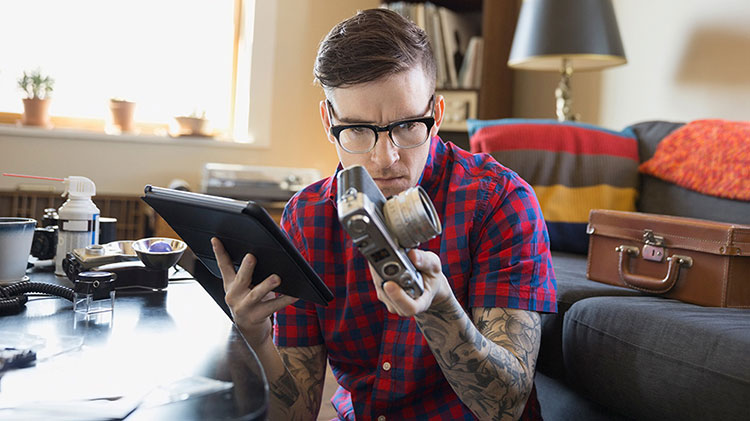 A man is reviewing the appraisal of an antique camera.