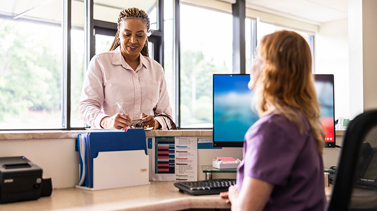 An HR rep checks with an employee about medical coverage.