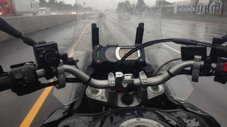 Motorcycle being ridden in the rain.