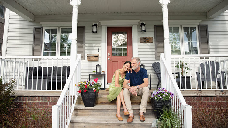 Couple on steps discussing paying off mortgage