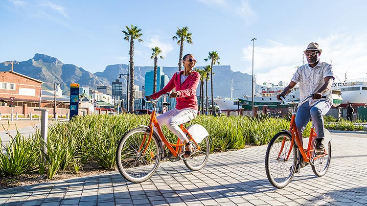 Mature man and woman riding their bikes on a trail.