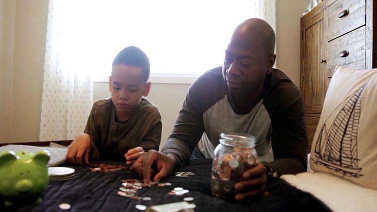 Father and son counting coins.