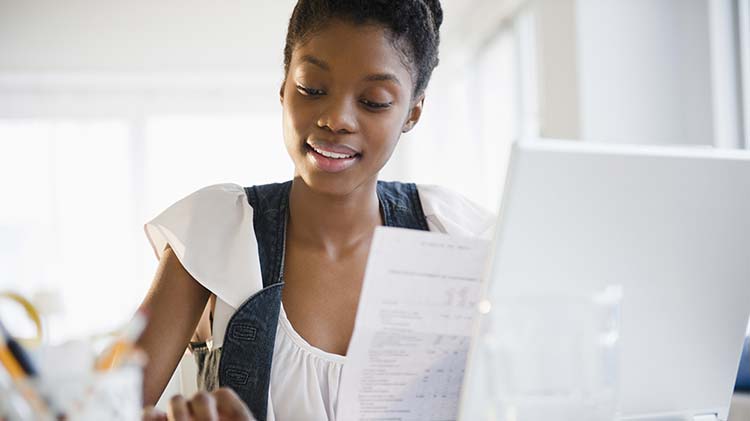 Woman closing her credit card after paying it off.