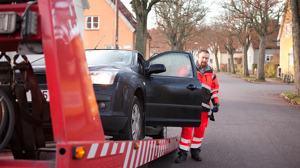 A car being towed after an auto accident.