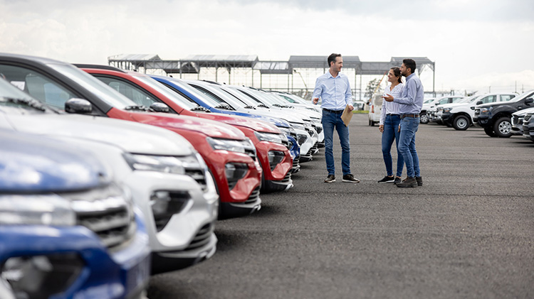 Couple at a dealership shopping for a car.
