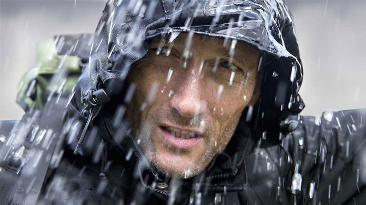 Man in rain gear during a storm.