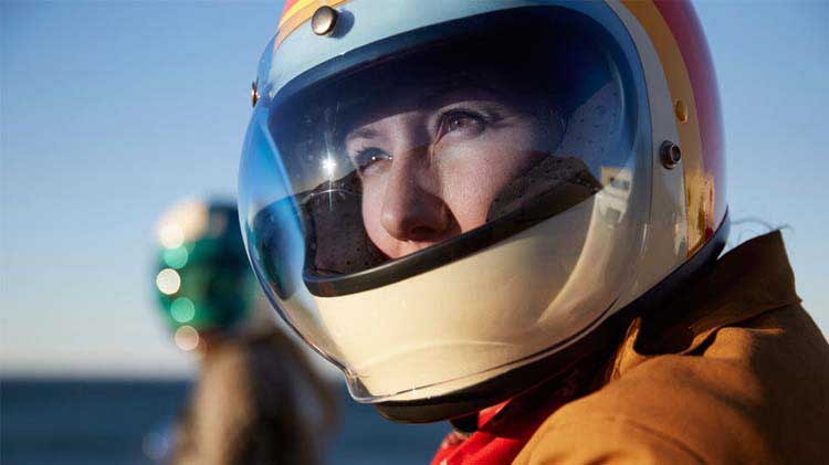 Woman wearing a motorcycle helmet.