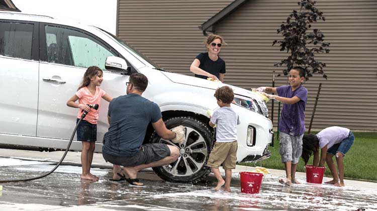 Family washing their car together