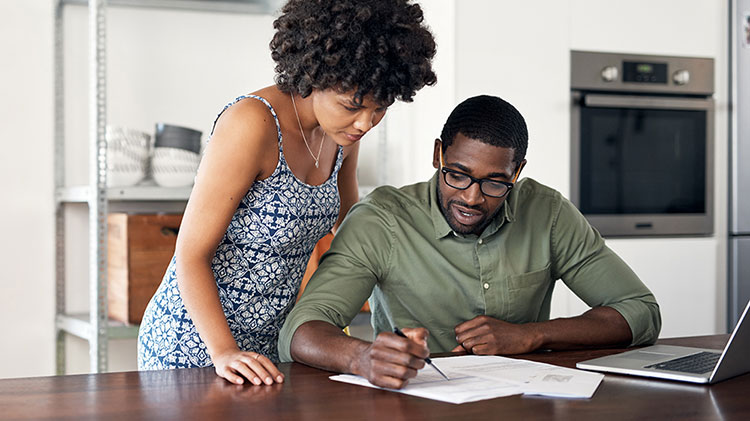 Couple filling out forms together.