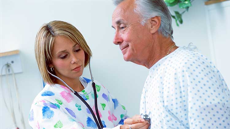 A nurse uses a stethescope on a patient