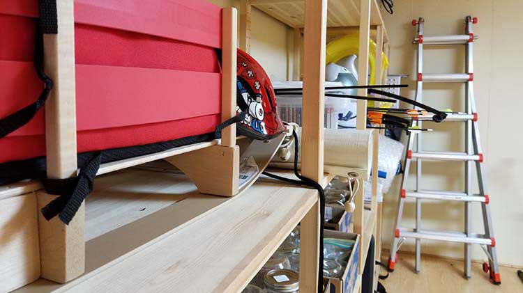 Basement showing items on shelves and items leaning against walls.