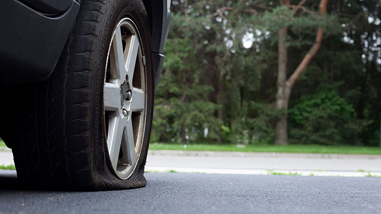 Flat tire created after a driving hazard.