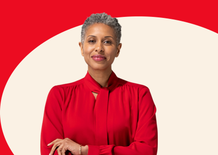 A mature State Farm agent in red blouse and ascot smiles.
