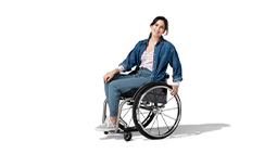 A young, Caucasian woman is seated in a wheelchair. She has dark hair that’s pulled back. She’s wearing a dark blue jacket, white shirt and jeans.