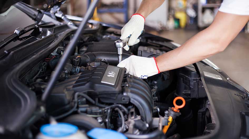 A mechanic provides engine maintenance.