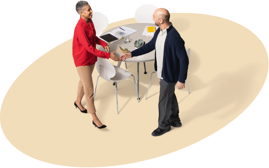 A female State Farm agent greets a gentleman in a black jacket.